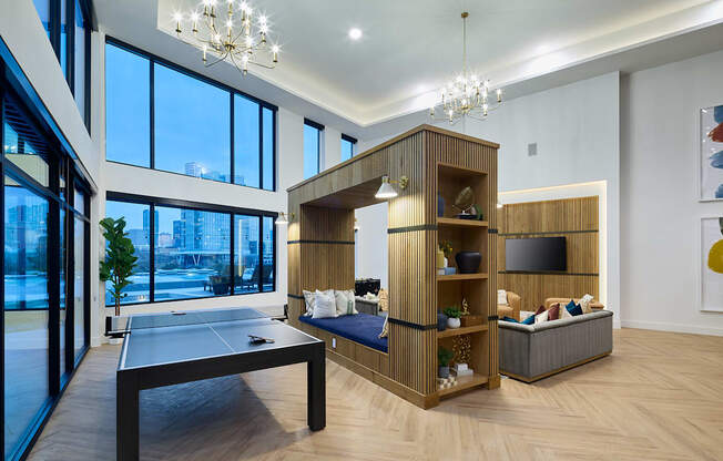 A modern living room with a pool table and a television.