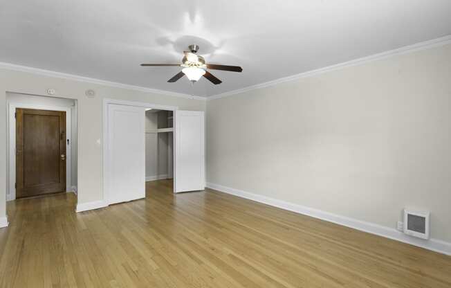 Expansive Living Room with plank flooring and a ceiling fan with light at Charbern Apartment Homes, Seattle, WA, 98122