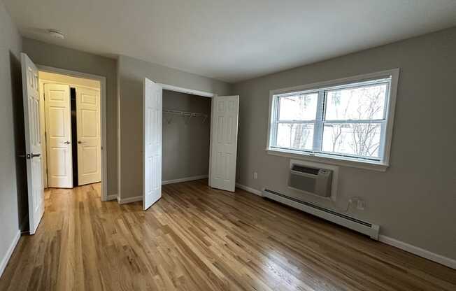 A room with wooden floors and a window.