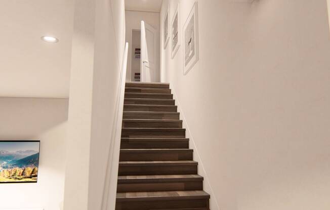 a staircase in a home with white walls and wood treads at Brownstones at Palisade Park Townhomes Broomfield Colorado