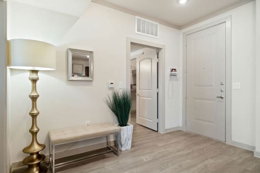 a corridor with a lamp and a bench