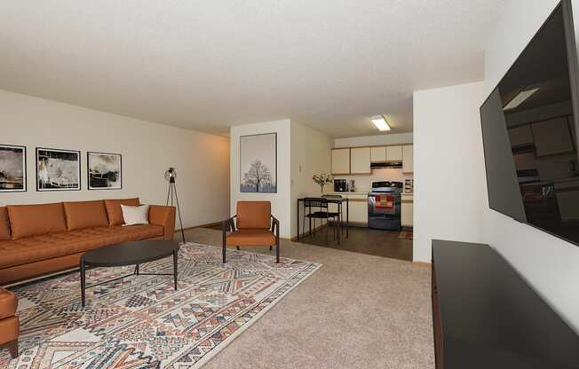 Fargo, ND Twin Parks Apartments. a living room with a brown couch and a black coffee table