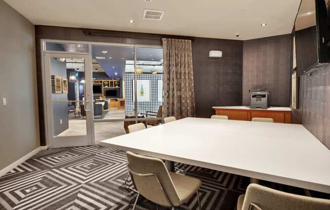 a meeting room with a large table and chairs