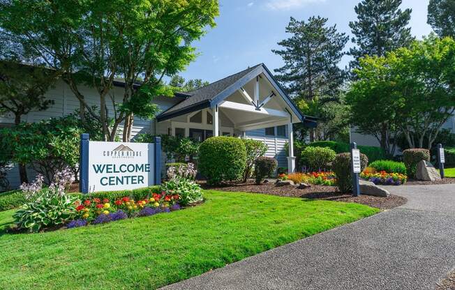 a welcome sign in front of a building with trees in the background Copper Ridge Apartments, Renton, 98055