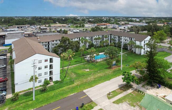 an aerial view of an apartment complex with a swimming pool