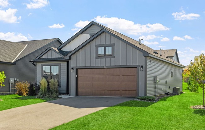 a house with a garage door and a driveway