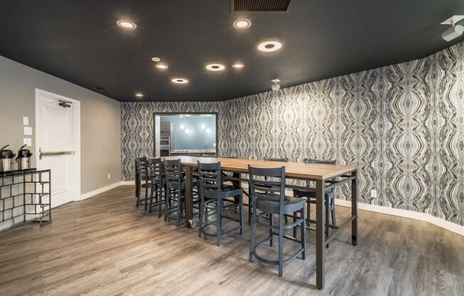 Community room with long table and high chairs, and a coffee maker in the corner