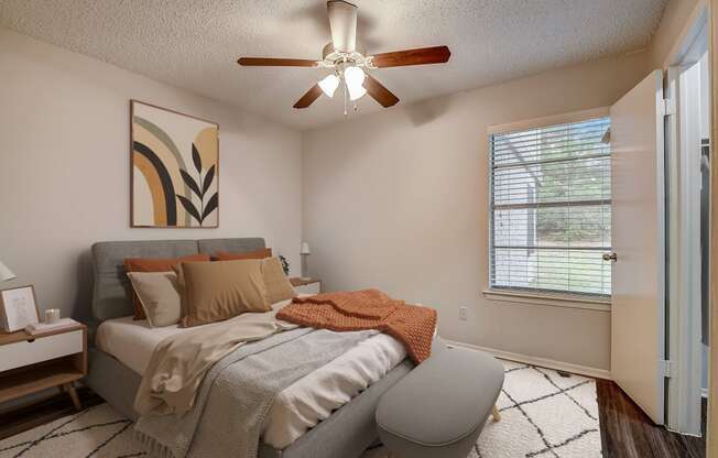 a bedroom with a large bed and a ceiling fan