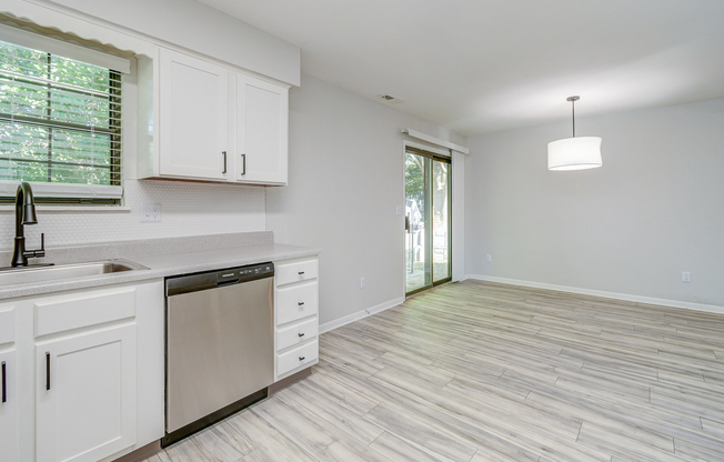 Stainless-steel dishwasher and white oak cabinets at The Arbor in Blue Springs, Missouri