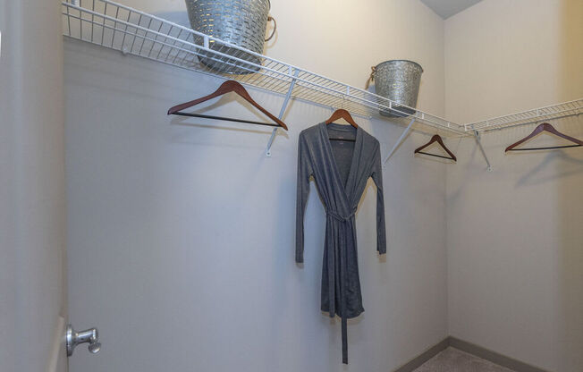 A hallway with a row of hangers and a dress hanging on one of them.