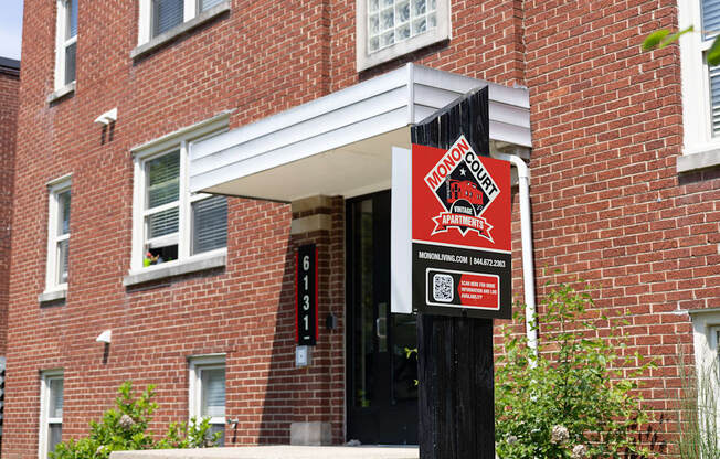 Close-up of leasing signage for Monon Court apartments at 6131 E 61st St, part of the Monon Living portfolio in Broad Ripple