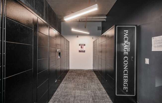 a hallway with black lockers and a welcome sign