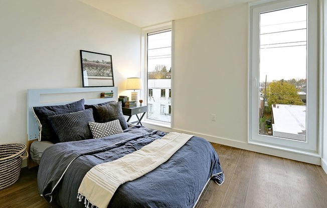 Large bedroom with 2 floor to ceiling windows. Bedroom can fit a queen or king sized bed.at 19th & Mercer, Seattle