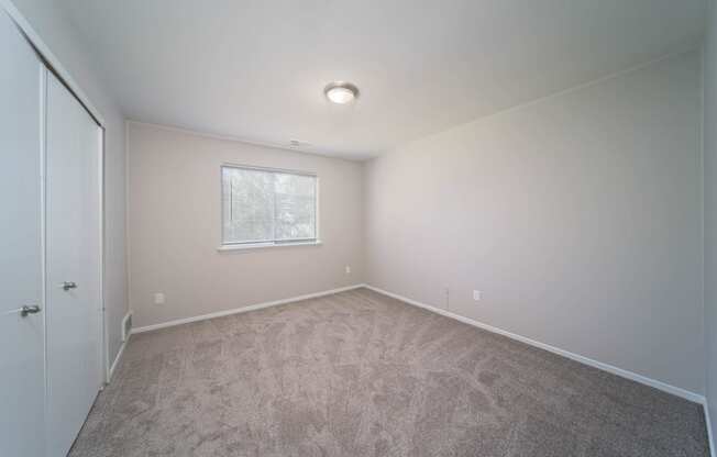 bedroom with white walls and window