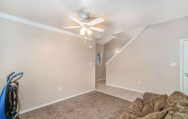 Beautiful two story townhome, crown molding, granite countertops, stained cabinets and carpeting in living area.