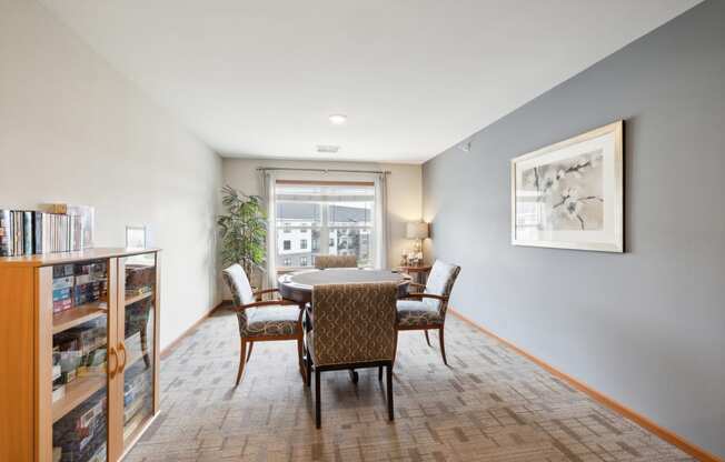 a dining room with a table and chairs and a window