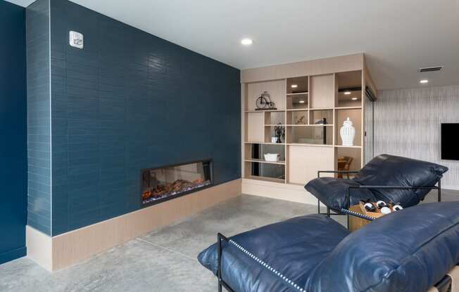 a living room with blue couches and a fireplace