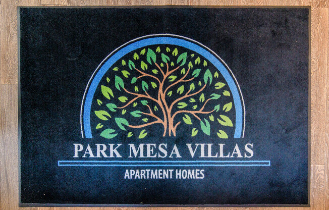 A sign for Park Mesa Villas Apartment Homes with a tree design.