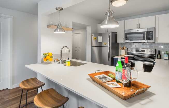 a kitchen with a large island with a tray of drinks and