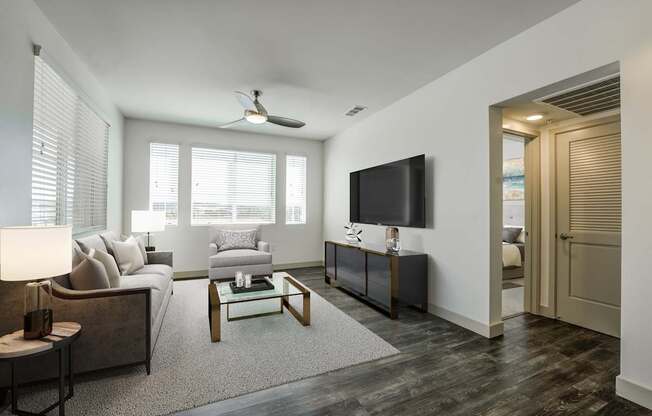 A living room with a couch, a coffee table, and a television at Montecito at Carlsbad, Carlsbad, CA 92010