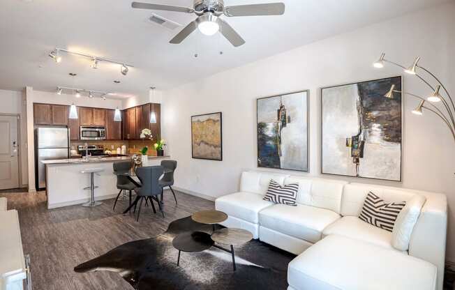 a living room and kitchen with a couch and a table