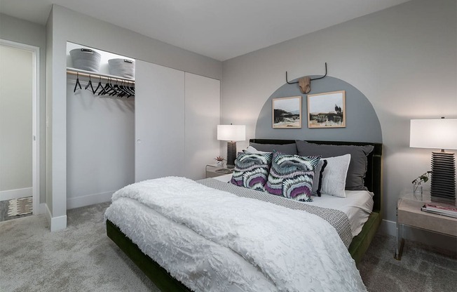 a bedroom with a bed and a closet at The Heights Apartments, Cincinnati, OH, 45220