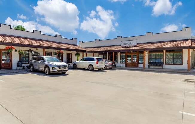 the front of a restaurant with two cars parked in front of it