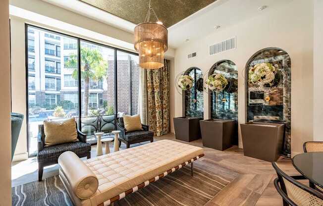 A living room with a large window and a view of a cityscape.