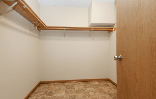 Anoka, MN Dellwood Estates Apartments. a large walk in closet in a bedroom with a tiled floor