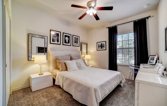 a bedroom with a large bed and a ceiling fan