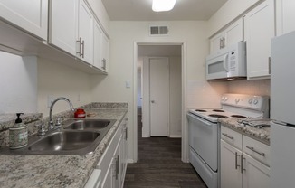 This is a photo of the kitchen room in the 970 square foot 2 bedroom, 2 bath apartment at Preston Park Apartments in Dallas, TX