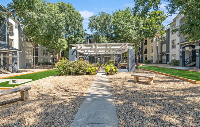 Community Courtyard with Benches at Allure North Dallas Apartments in Dallas, TX.