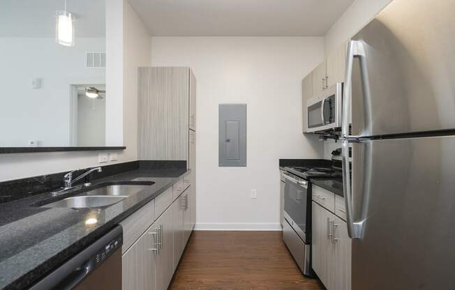 a kitchen with granite countertops and stainless steel appliances