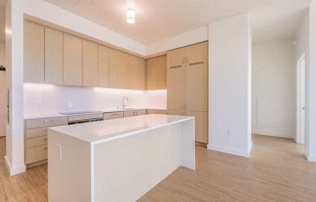 A kitchen with wooden cabinets and a white island.