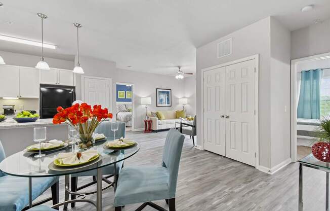 A dining room with a glass table and chairs.
