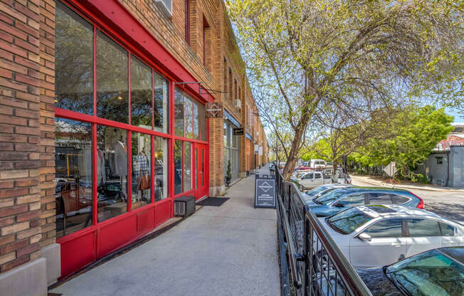 a brick building with a red exterior and a sidewalk in front of it