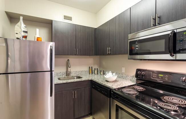 a kitchen with stainless steel appliances and granite counter tops