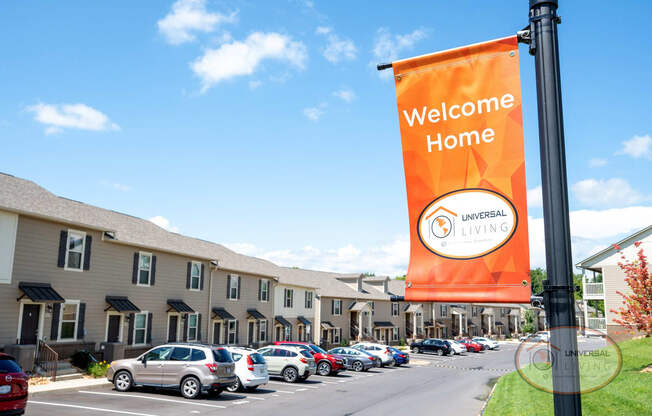 a welcome home banner in front of a hotel parking lot