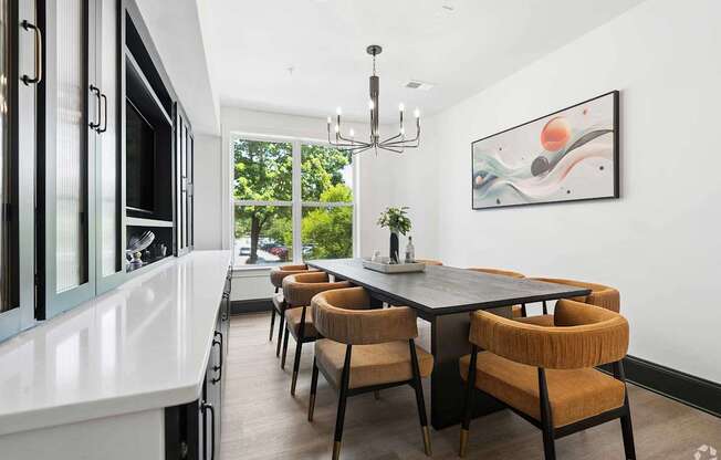 A modern dining room with a large table and chairs.