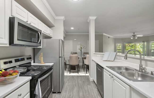 a kitchen with a counter top with a sink and a microwave