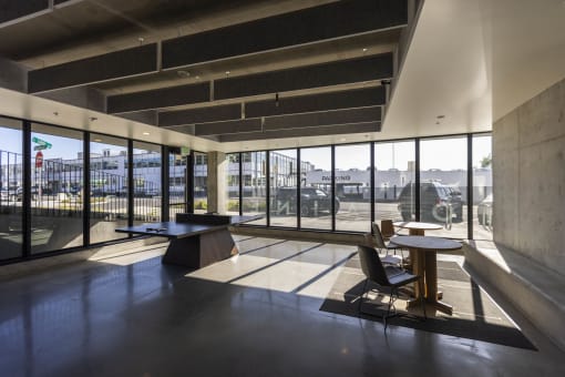 the lobby of a building with large windows and a table and chairs at Moraine, Tacoma, Washington