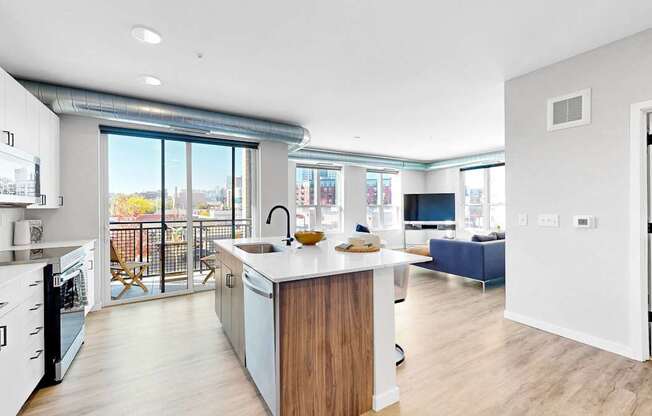 A modern kitchen with a wooden island and a view of the city.