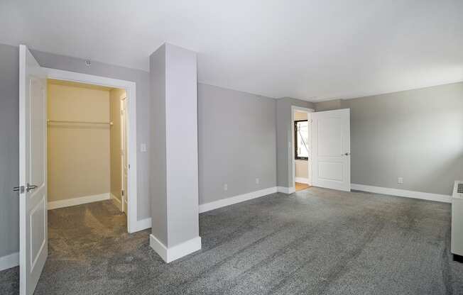 A room with a carpeted floor and white walls.