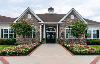 A house with a black front door and a brick facade.