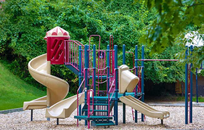 a playground with a slide and other toys in a park