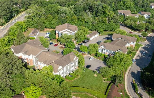 a aerial view of a neighborhood of houses with cars parked in front of them