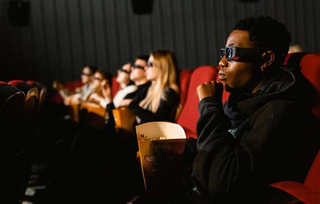 a group of people watching a movie with goggles on