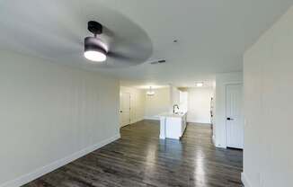 A spacious room with a white table and a light fixture on the ceiling.