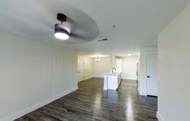 A spacious room with a white table and a light fixture on the ceiling.