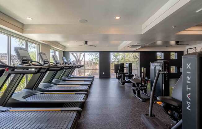 a row of treadmills and exercise machines in a fitness room at slate scottsdale